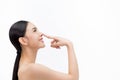 Young attractive woman touching her nose with fingertip over isolated white background Royalty Free Stock Photo