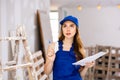 Young attractive woman in uniform makes notes on pape Royalty Free Stock Photo