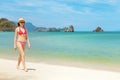 Young attractive woman walking on the sea beach Royalty Free Stock Photo