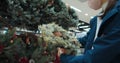 Portrait of young woman shopping in supermarket Christmas wreath