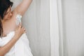 Young attractive woman in white towel shaving armpit with depilation cream and plastic razor in home bathroom. Skin care. Hair Royalty Free Stock Photo