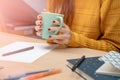 Young attractive woman working from home on her workplace with coffee. Royalty Free Stock Photo