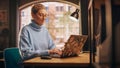 Young Attractive Woman Working from Home on Laptop Computer with Stickers in Sunny Stylish Loft Royalty Free Stock Photo