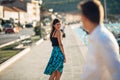 Young attractive woman flirting with a man on the street.Flirty smiling woman looking back on a handsome man.Female attraction Royalty Free Stock Photo