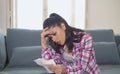 Young attractive and worried hispanic woman checking bills bank papers expenses and monthly payments in stress at apartment living Royalty Free Stock Photo