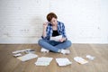 Woman at living room floor with calculator and bank and bills paperwork and documents doing domestic financial accounting