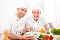 Young attractives professionals chefs cooking together Royalty Free Stock Photo