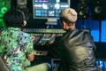 Young audio engineer people having fun working with mixer sound panel control inside music recording studio Royalty Free Stock Photo