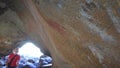 Tourist looking at Aboriginal australian indigenous rock painting in Mulkas Cave Hyden Western Australia