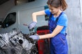 Young auto mechanic repairs the engine of a modern car Royalty Free Stock Photo