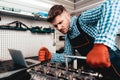 Young Auto Mechanic Twists A Nut. Service Station.