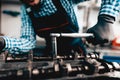 Young Auto Mechanic Twists A Nut. Service Station.