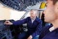 Young aviation technician in cockpit with trainer