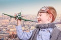 Young aviator playing with toy airplane