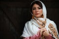 Young azeri woman in traditional Azerbaijani dress standing at the wooden door