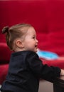 Young baby girl in black shirt from her side