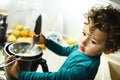 Young baby girl helps prepare a cake using a food processor