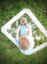 Young baby looking at self in mirror while smiling Royalty Free Stock Photo