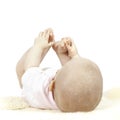 Young baby playing with her toes Royalty Free Stock Photo