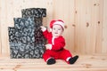 Young baby wearing a santa claus suit and hat in christmas in a barn Royalty Free Stock Photo