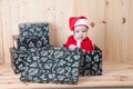 Young baby wearing a santa claus suit and hat in christmas in a barn Royalty Free Stock Photo