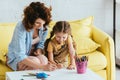 Babysitter and adorable kid drawing with Royalty Free Stock Photo