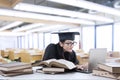 Young bachelor studying in library 1 Royalty Free Stock Photo