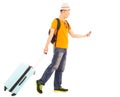 Young backpacker carrying a baggage and holding a smartphone