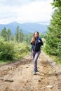 Young backpacker woman enjoying mountain trip Royalty Free Stock Photo