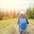 Young backpacker woman enjoying mountain trip Royalty Free Stock Photo