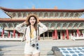 Young backpacker woman stand before traditional chinese temple