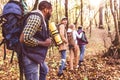 Young backpackers in autumn forest