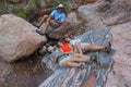 Young backpackers resting in Hance Creek in the Grand Canyon.