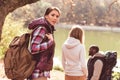 Young backpackers walking near river