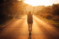 Young backpacking adventurous woman hitchhiking on the road. Ready for adventure of life. Travel lifestyle. Low budget traveling. Royalty Free Stock Photo