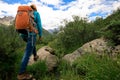 Backpacking woman hiking in mountains