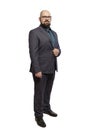 Young bald bearded man with glasses and a full-length suit. Isolated over white background. Royalty Free Stock Photo