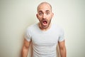 Young bald man with beard wearing casual white t-shirt over isolated background afraid and shocked with surprise expression, fear Royalty Free Stock Photo