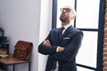 Young bald man business worker standing with arms crossed gesture and serious expression at office Royalty Free Stock Photo