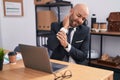 Young bald man business worker suffering for neck pain working at office Royalty Free Stock Photo