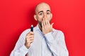 Young bald man holding removable memory usb covering mouth with hand, shocked and afraid for mistake Royalty Free Stock Photo