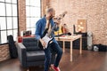 Young bald man musician playing electrical guitar standing at music studio Royalty Free Stock Photo