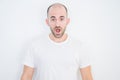 Young bald man over white isolated background afraid and shocked with surprise expression, fear and excited face Royalty Free Stock Photo