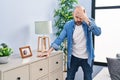 Young bald man suffering dizzy standing at home