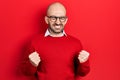 Young bald man wearing casual clothes and glasses excited for success with arms raised and eyes closed celebrating victory smiling Royalty Free Stock Photo