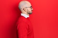 Young bald man wearing casual clothes and glasses looking to side, relax profile pose with natural face with confident smile Royalty Free Stock Photo