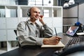 Young bald man working in a call center office Royalty Free Stock Photo