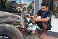Young Balinese man renews old car