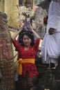 A young Balinese woman bringing the main offering in traditional clothes on Hindu Temple ceremony, Bali Island, Indonesia Royalty Free Stock Photo