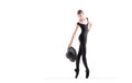 Young ballerina in black pointe shoes and black bondage costume posing on white background with hat in hand Royalty Free Stock Photo